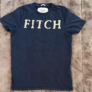 Abercrombie & Fitch Men's Dark Blue Tee with Gold Lettering